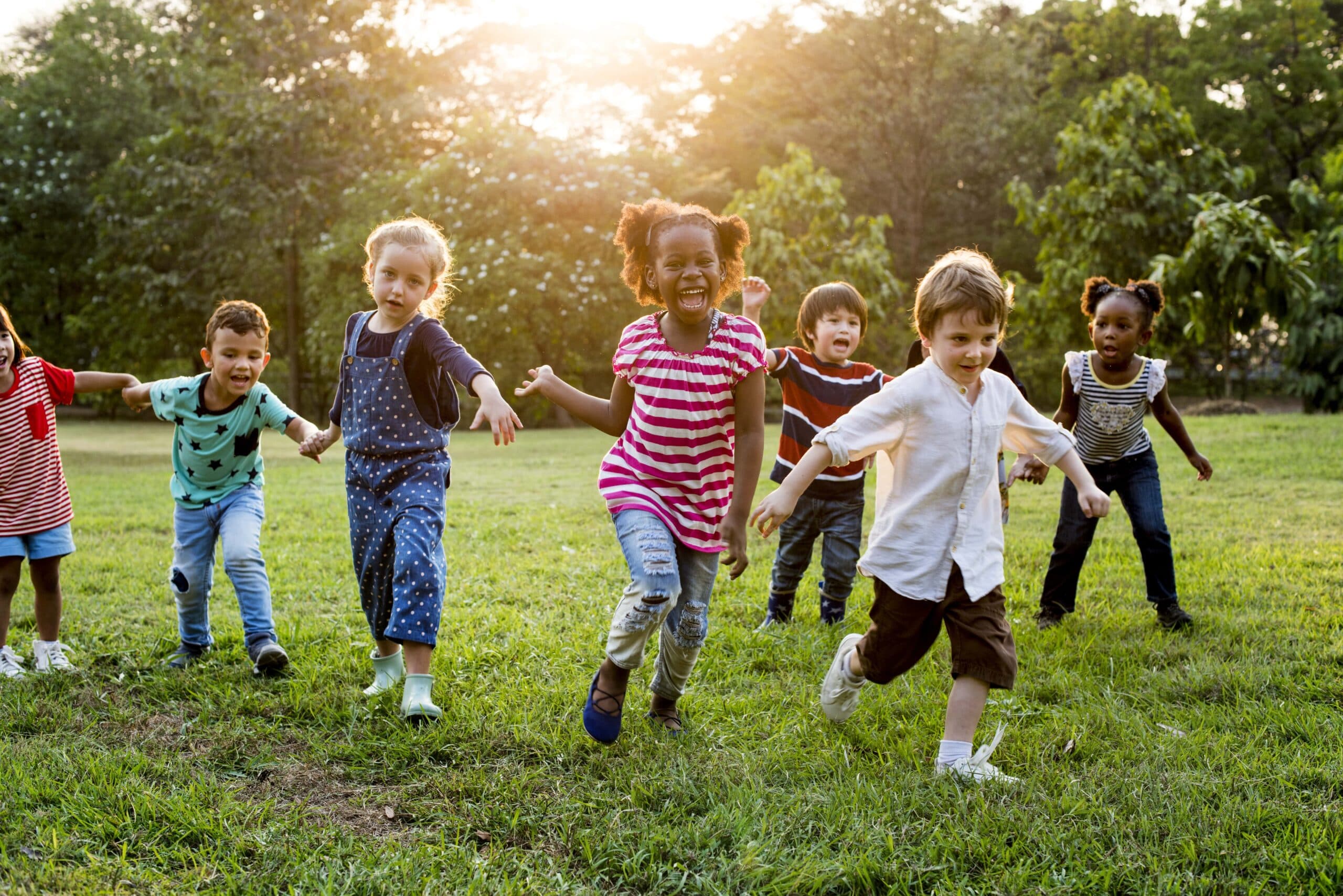 group-diverse-kids-playing-field-together-min